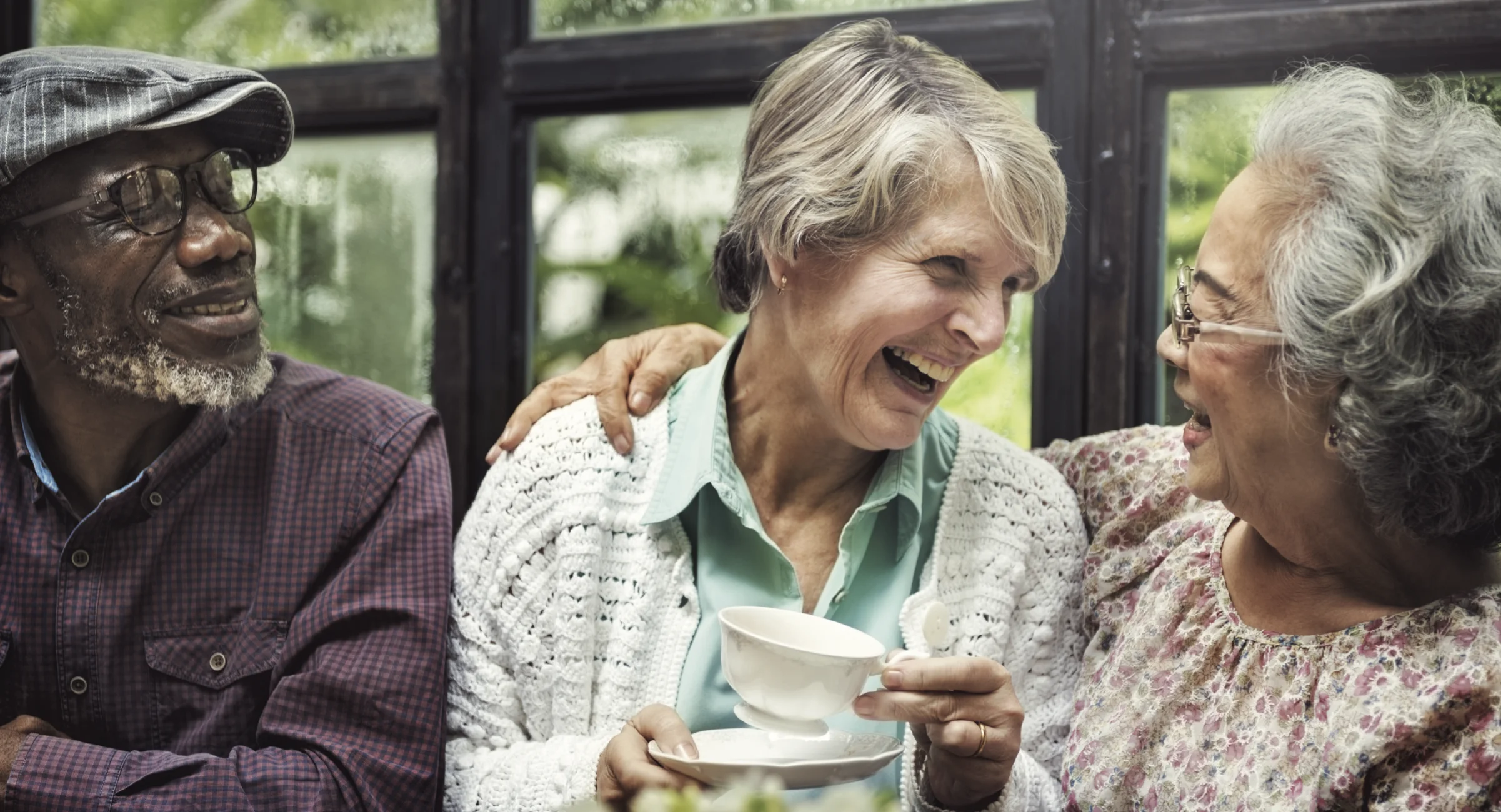 Smiling elderly with a cup of tea