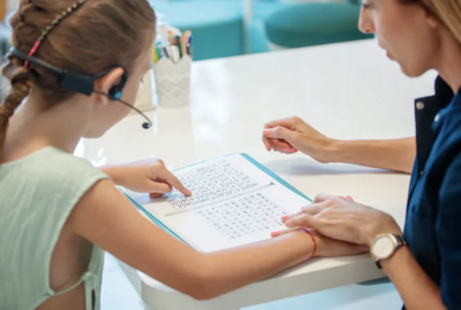 a child with learning difficulties reading with carer