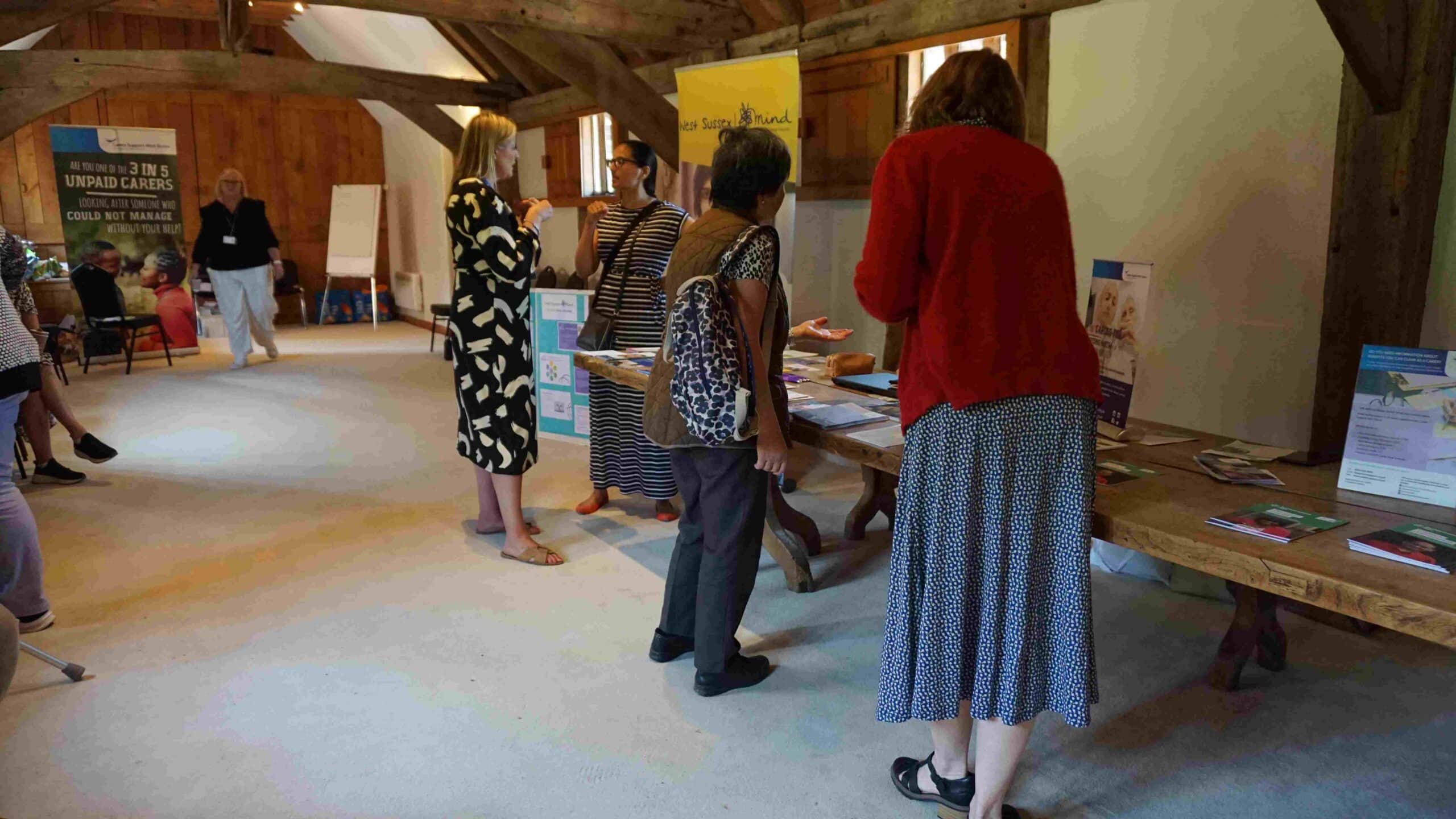 Carers information event with women looking at pamphlets