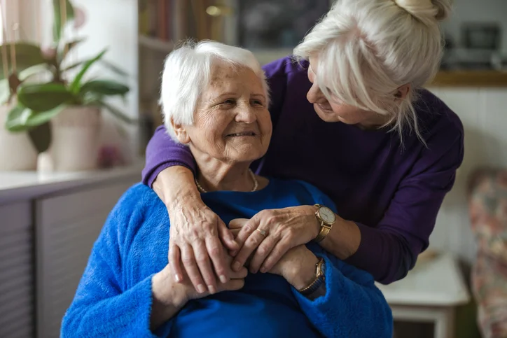 daughter hugging elderly mum