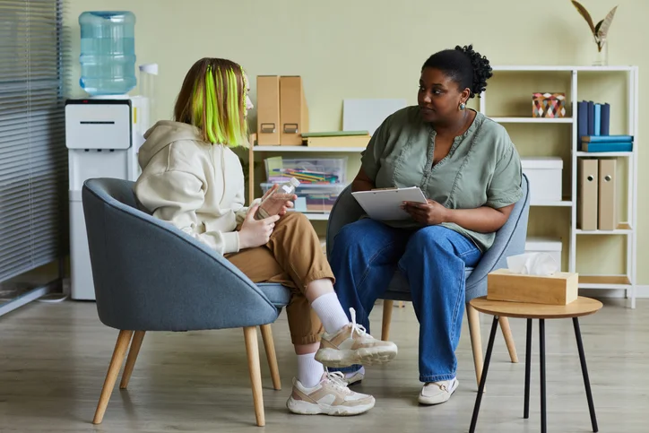 counselling session with young woman with green hair