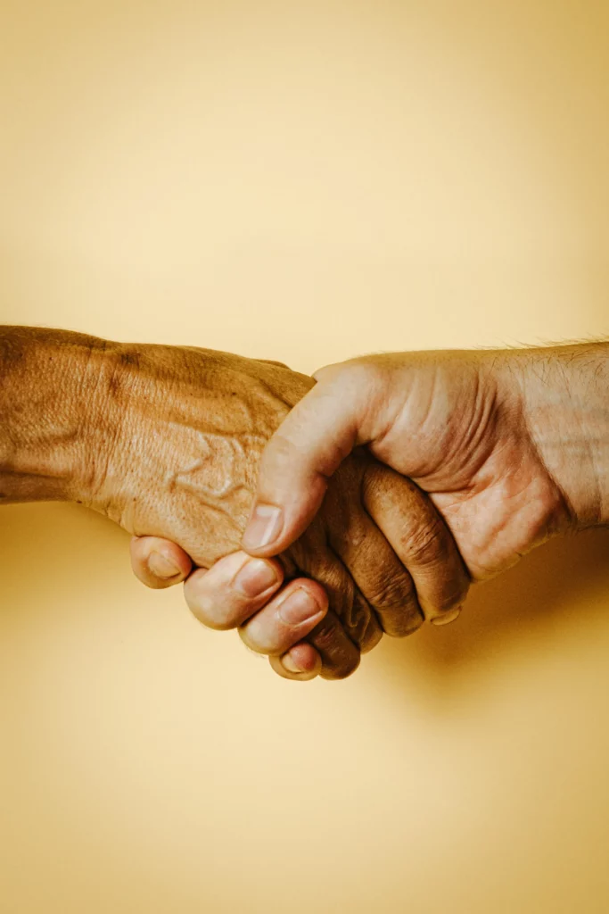 holding hands on yellow background