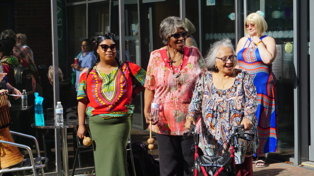 Elderly women in African print outside of Crawley museum