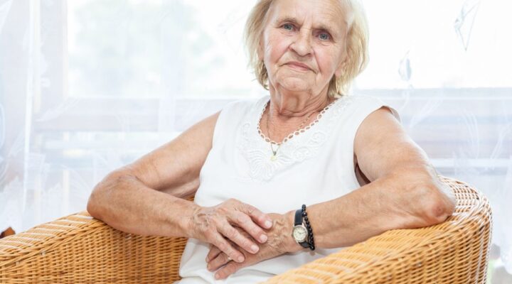 Carer story image with elderly woman sitting in wicker chair