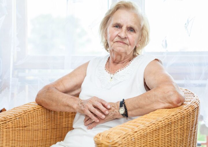 Carer story image with elderly woman sitting in wicker chair