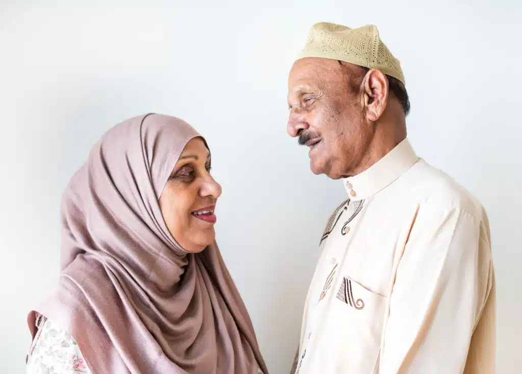 Asian Muslim Carers (wife and husband) looking at each other